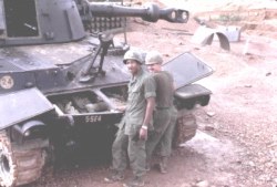 SSG Floyd, Chief of Firing Btry inspecting a howitzer 